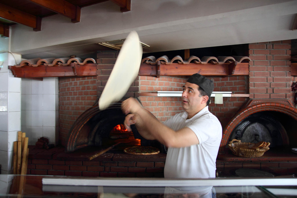 the chef virtuoso rolling pizza dough